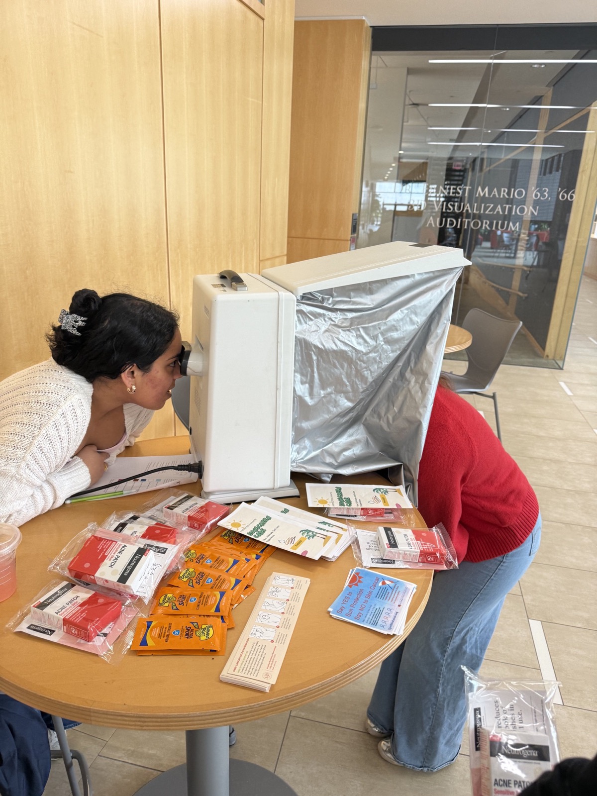 A student using a skin-analysis station during a PhASEd educational event